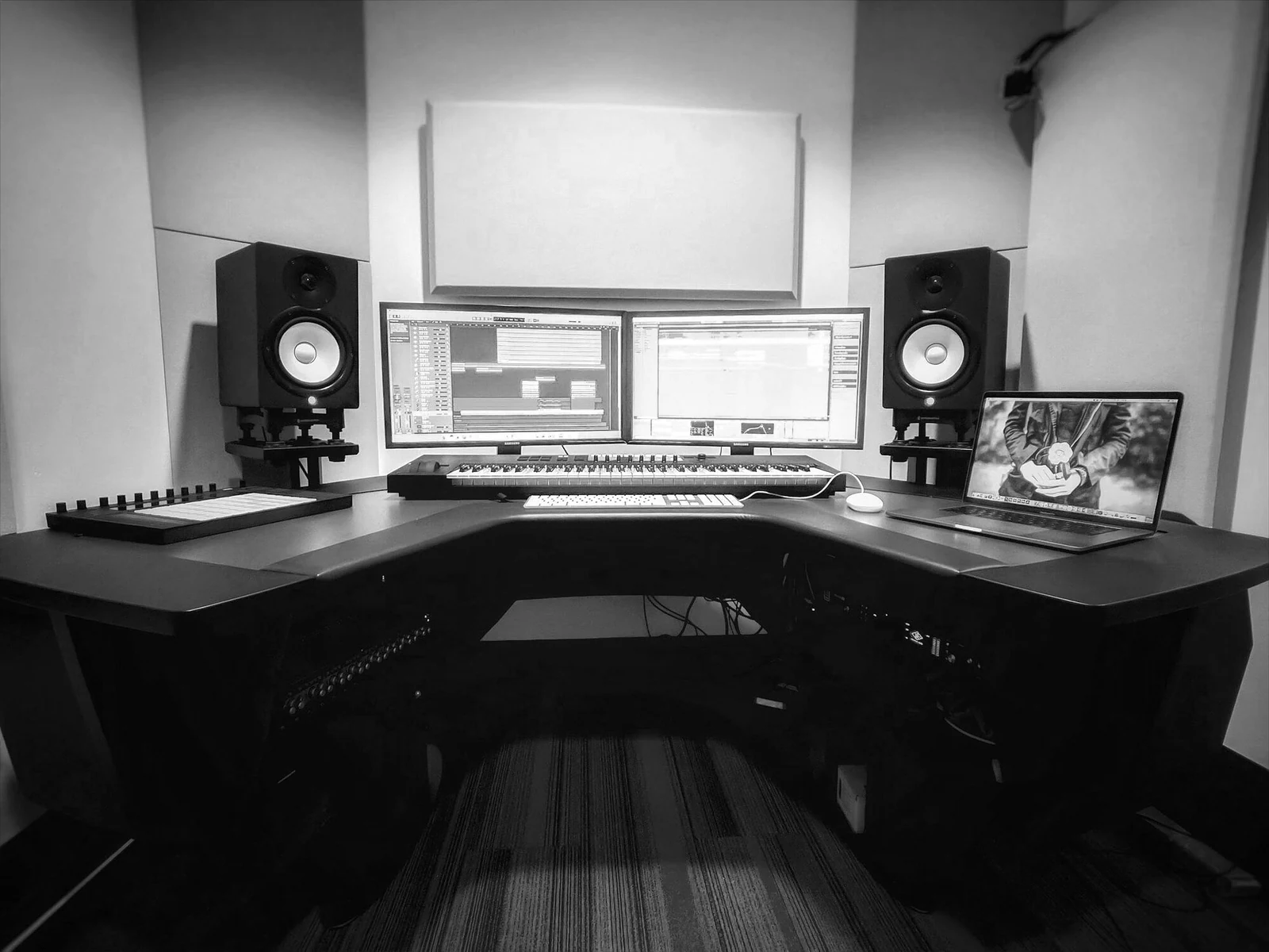 a computer desk with two monitors and a keyboard. Photograph accompanying Velaharra’s career development guide.