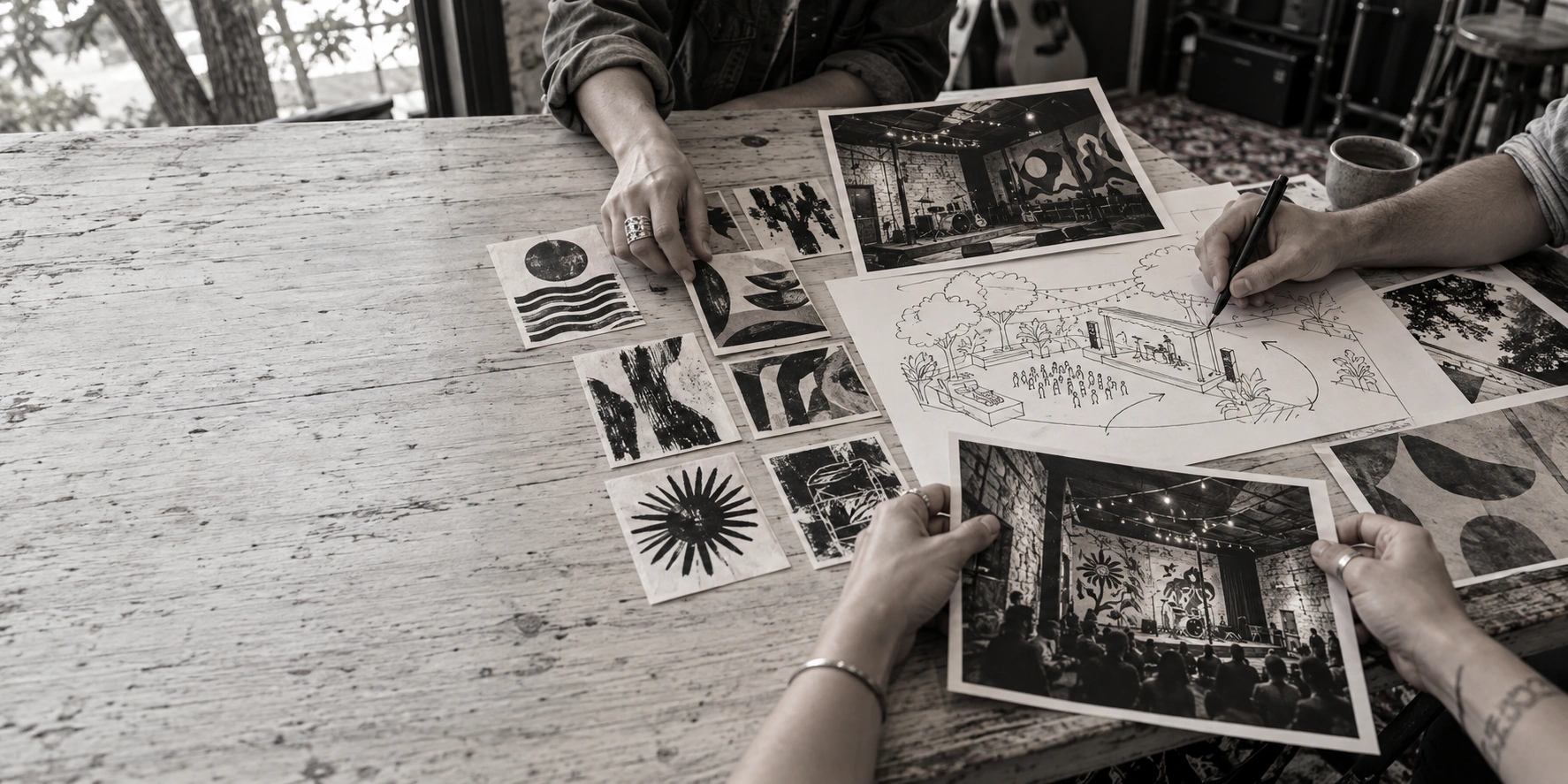 Hands developing a live music experience with concert sketches, artwork, and Austin venue photographs